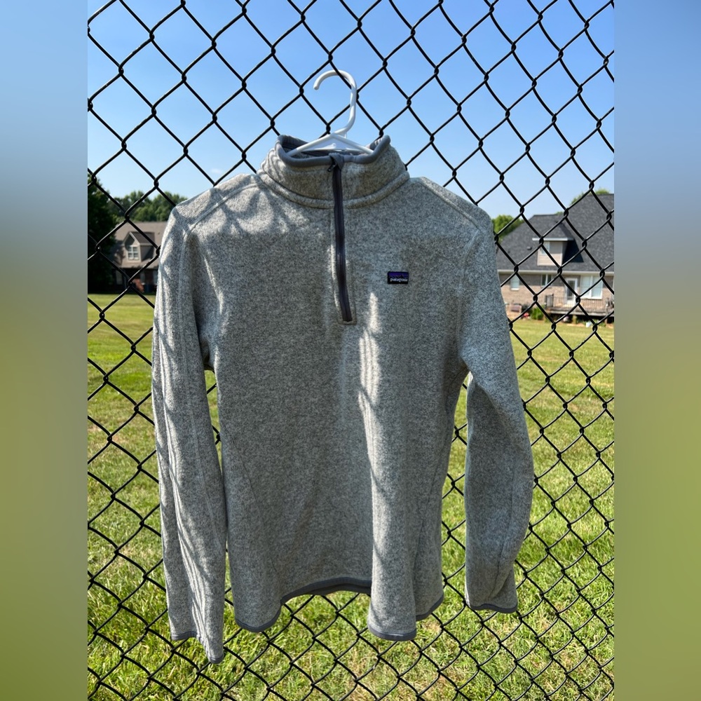 Patagonia grey 1/4 zip jacket with small pocket of sleeve.